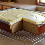 Banana Cake Mix Recipe: Moist, Easy & Topped with Creamy Frosting 5 Frosted banana cake in baking dish